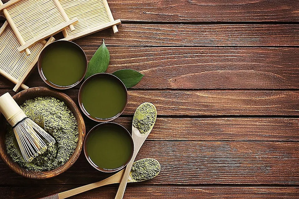 Finely milled green powder with a bowl and whisk